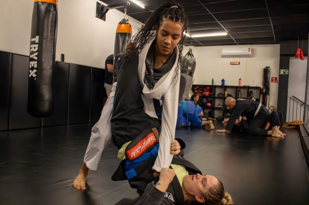 Women training Brazilian Jiu-Jitsu guard and passing positions