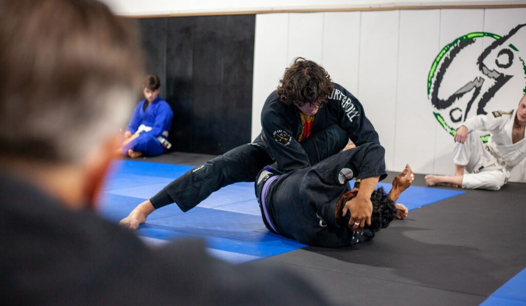 Gi grapplers practicing upper-body control during class