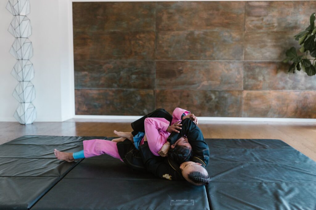 Grapplers practicing a lower-body control position