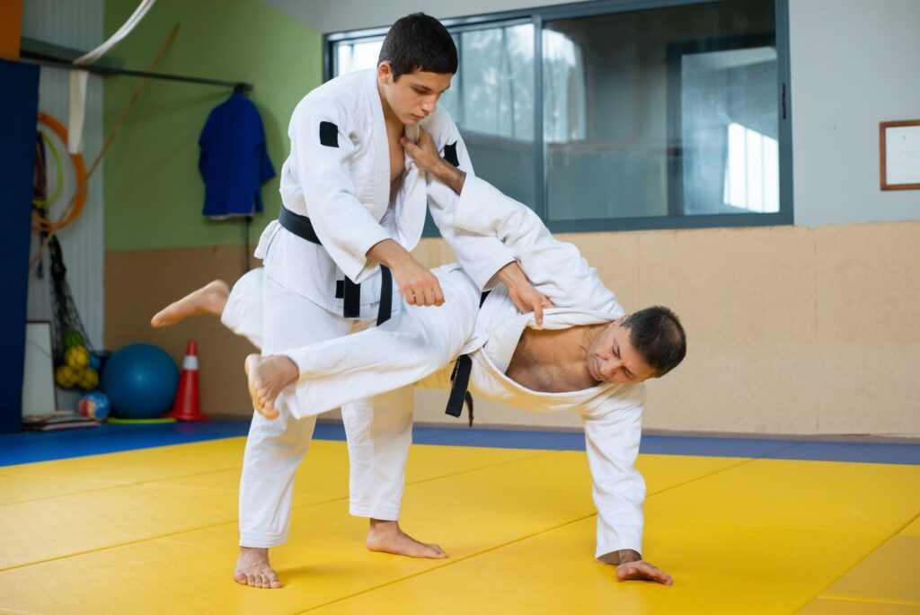 Judoka moving around a standing defensive position