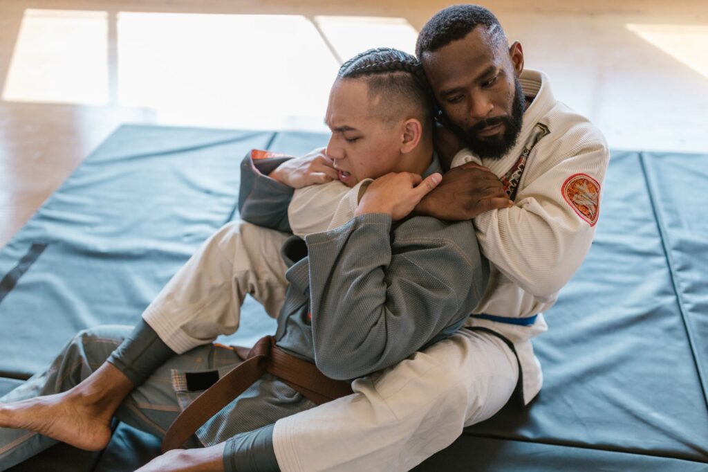 Gi grapplers working from a back-control position