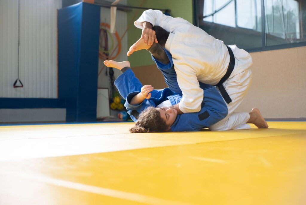 Adult martial artists drilling beneath controlled top pressure