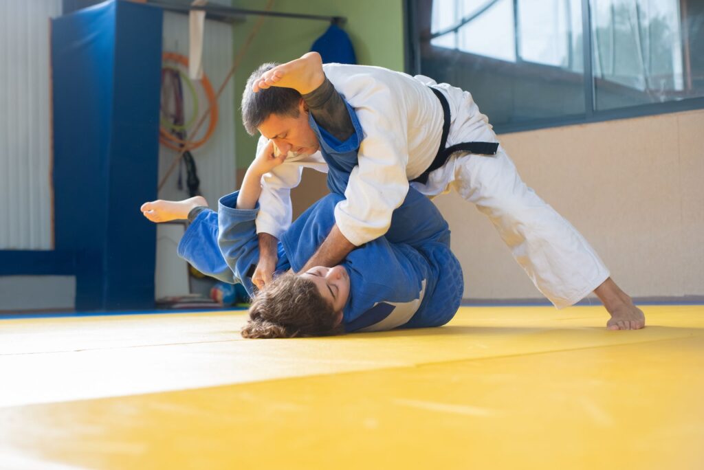 Adult martial arts instructor demonstrating controlled top pressure
