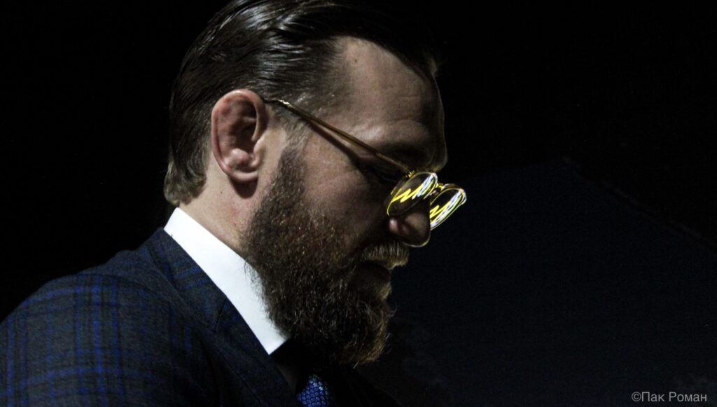 Conor McGregor wearing sunglasses and a dark suit