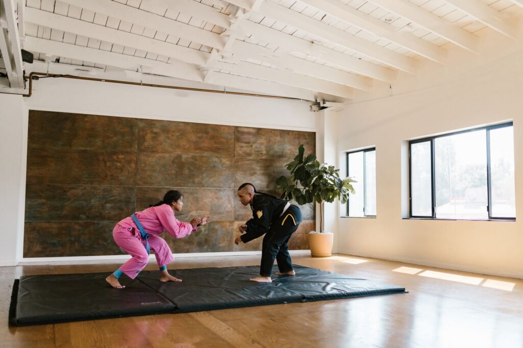 Adult grapplers practicing a defensive movement under top pressure