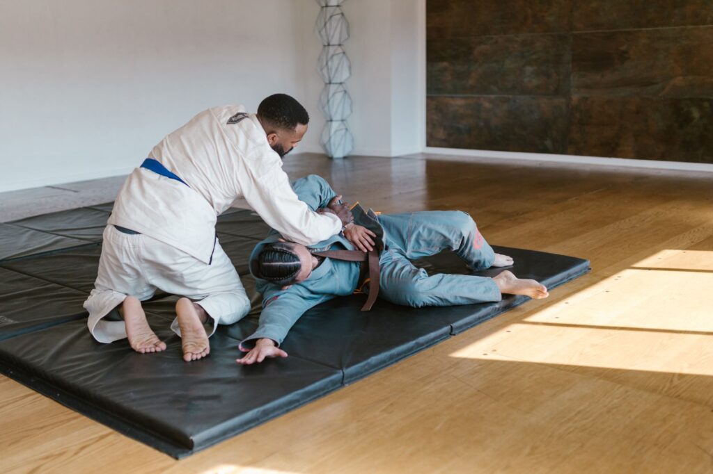 Adult Brazilian jiu-jitsu partners practicing a top position