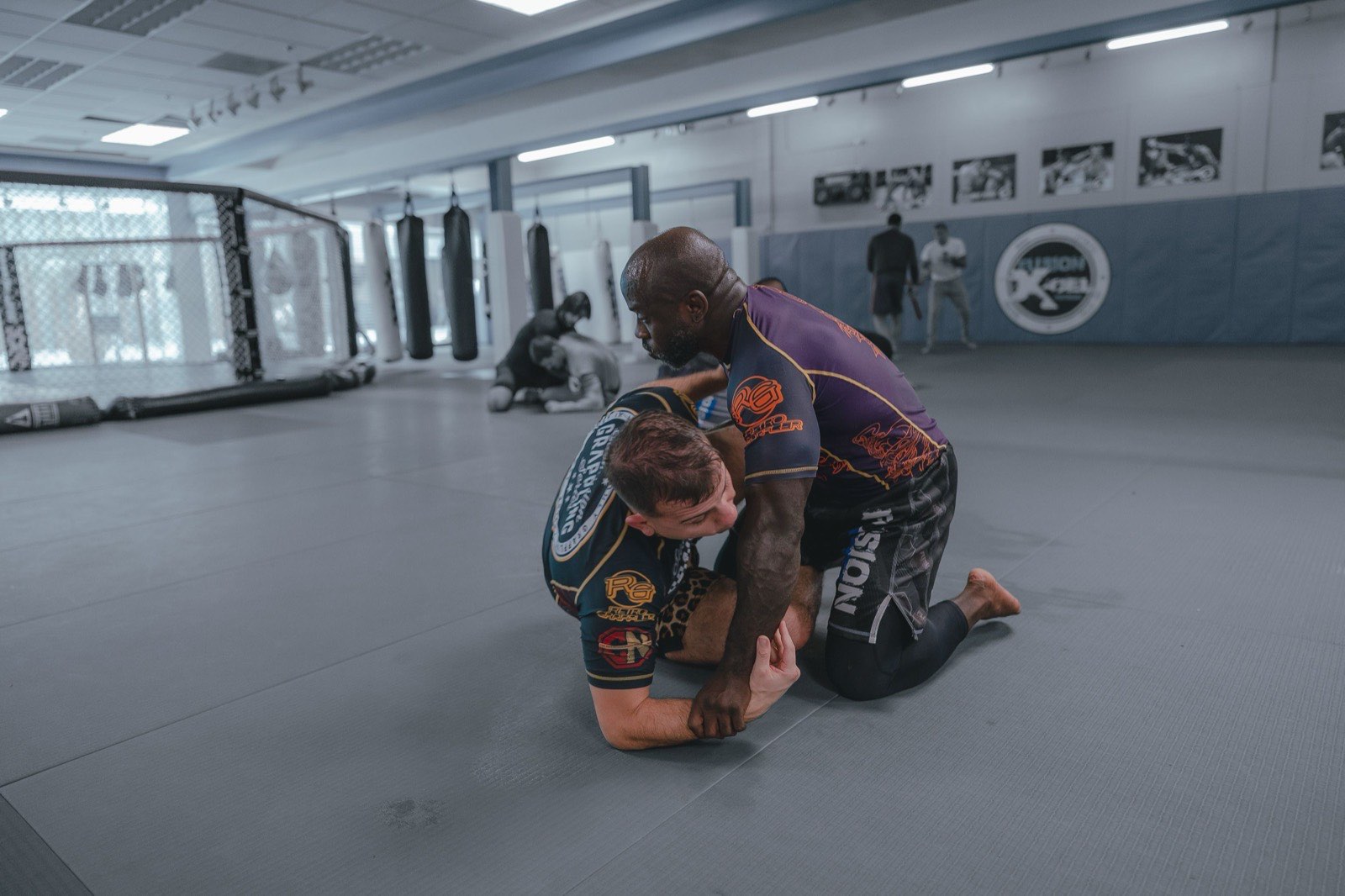 Two athletes grappling in a no-gi Brazilian Jiu-Jitsu match