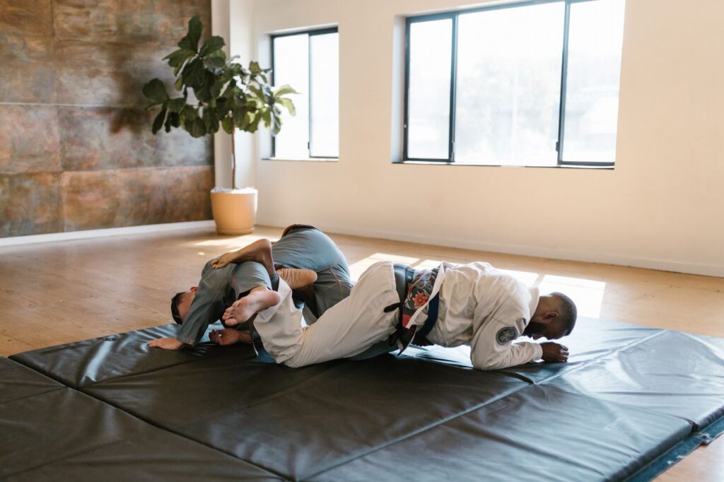 Gi grapplers drilling from a close ground-control position