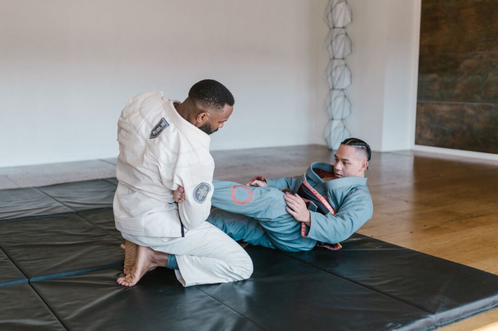 Gi grapplers practicing a controlled lower-leg position