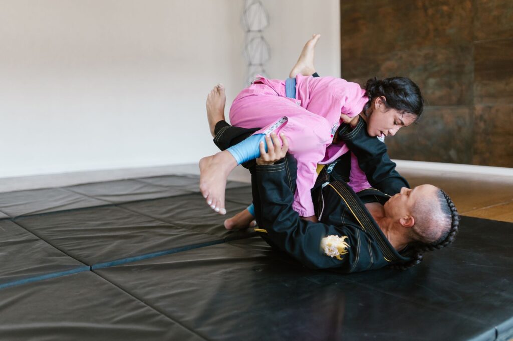 Gi grapplers drilling a controlled ground position