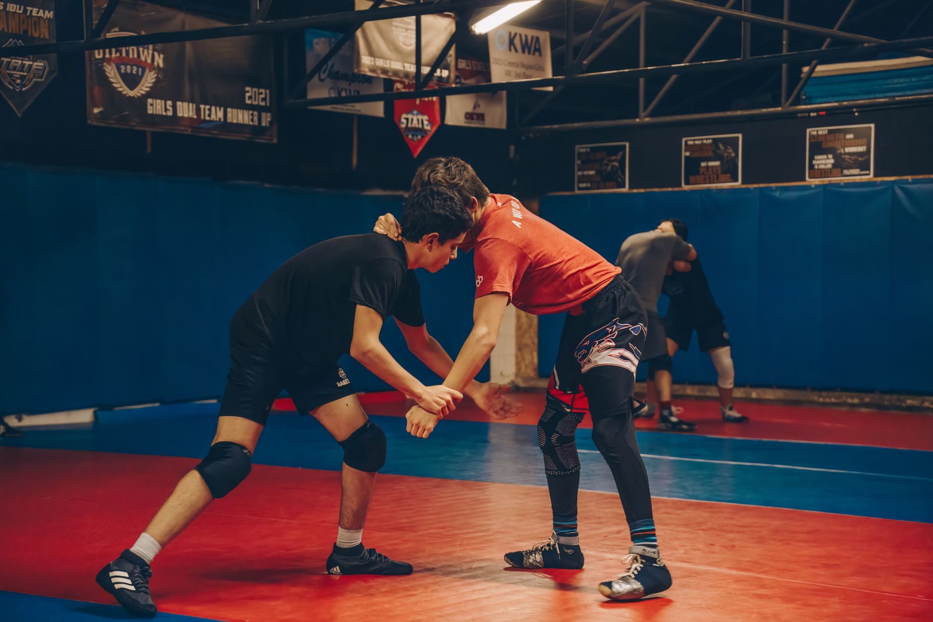 Two wrestlers in a tie-up stance at the start of a wrestling exchange