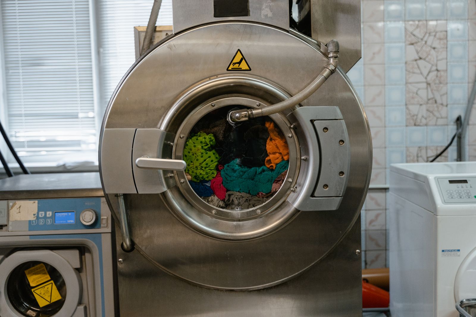 Clothes inside a large front-loading washing machine